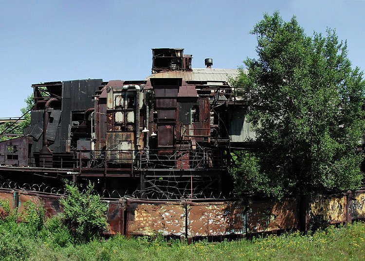 Horizontal Panorama of rusty building near railyard